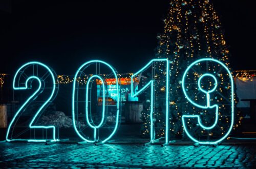 Bright neon '2019' sign with Christmas tree, perfect for New Year's festivities.
